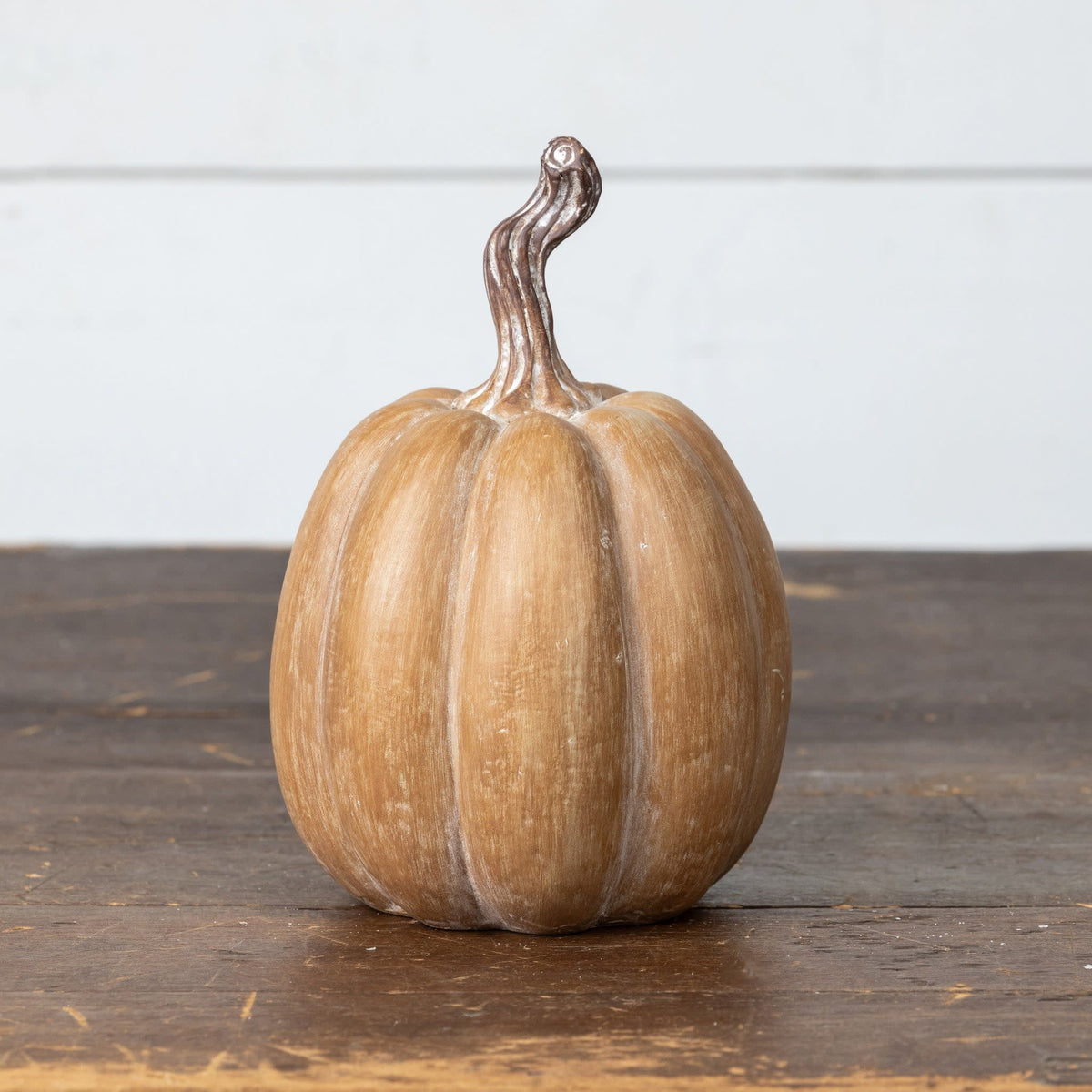 Brown resin pumpkin with rustic texture measuring 7.25 inches tall.
