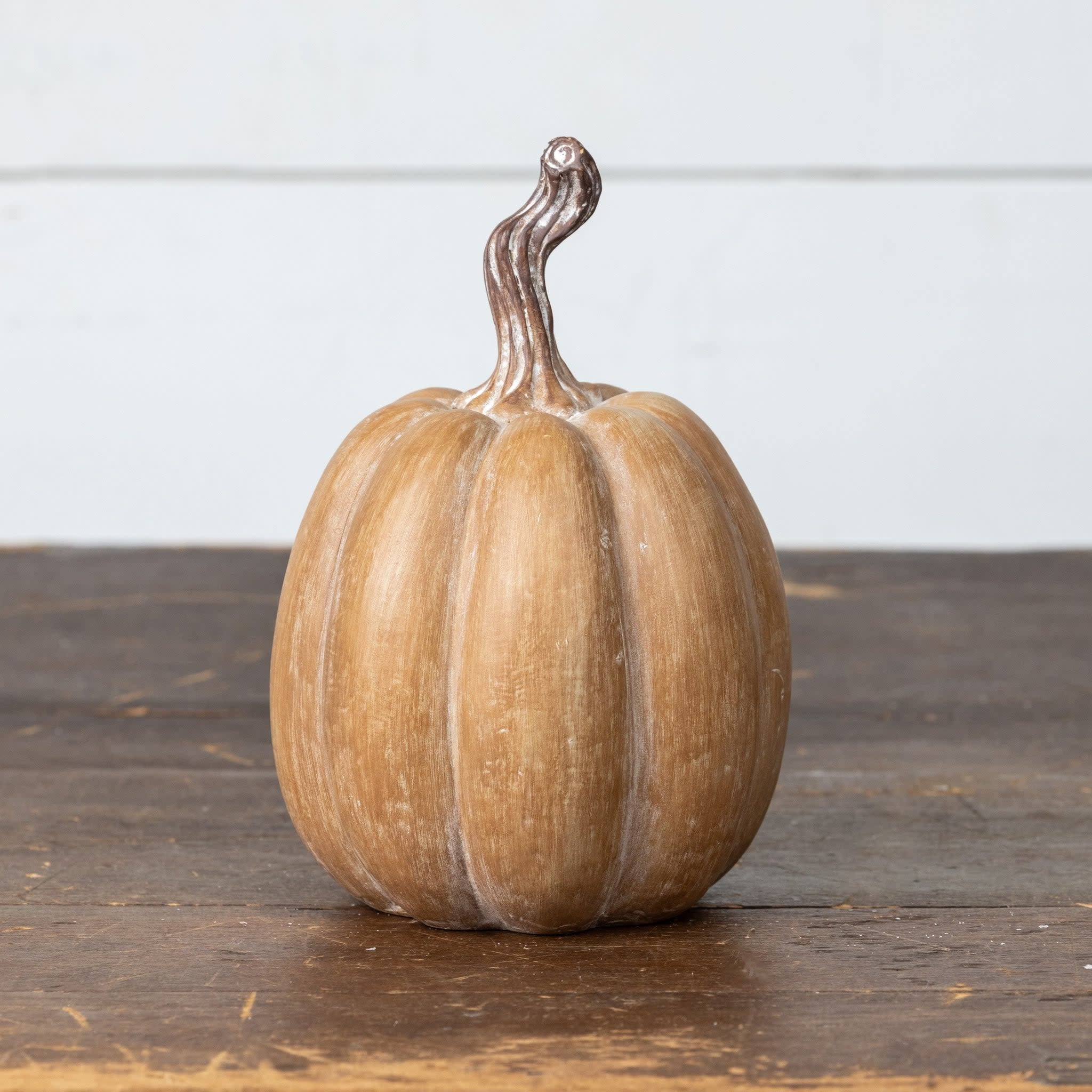 Brown resin pumpkin with rustic texture measuring 7.25 inches tall.