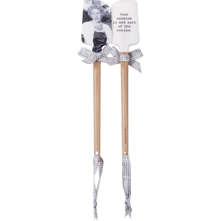 Double-sided silicone spatula with wooden handle featuring vintage photo on one side and text 'Your Opinion Is Not Part Of The Recipe' plus gray gingham bow.