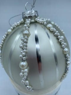 4-inch glass ball ornament in cream with vertical silver stripes and pearl bead accents.