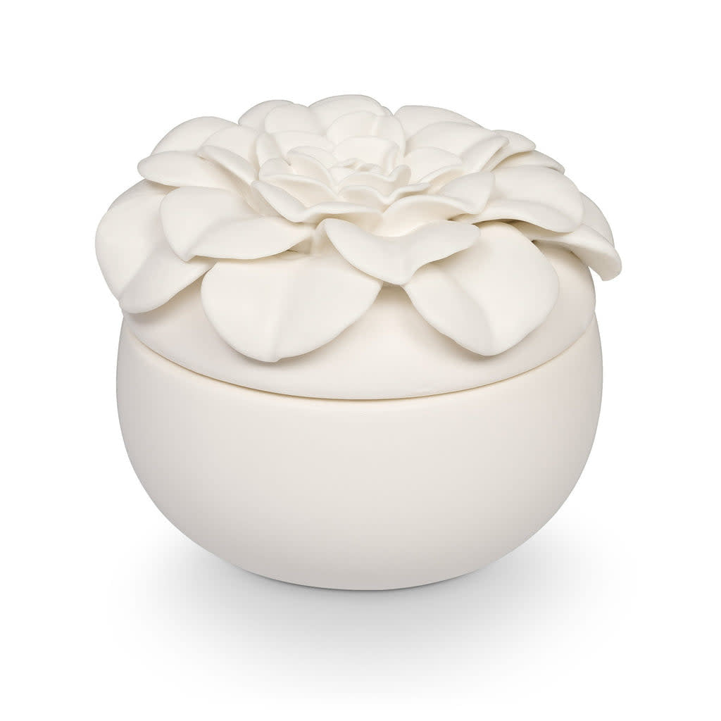 Ceramic flower candle in Citrus Crush scent with three wicks inside a petal-shaped vessel.