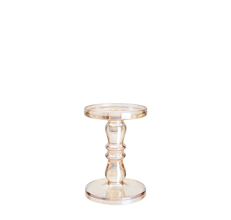 Clear glass candle holder with a diamond star cutout base.