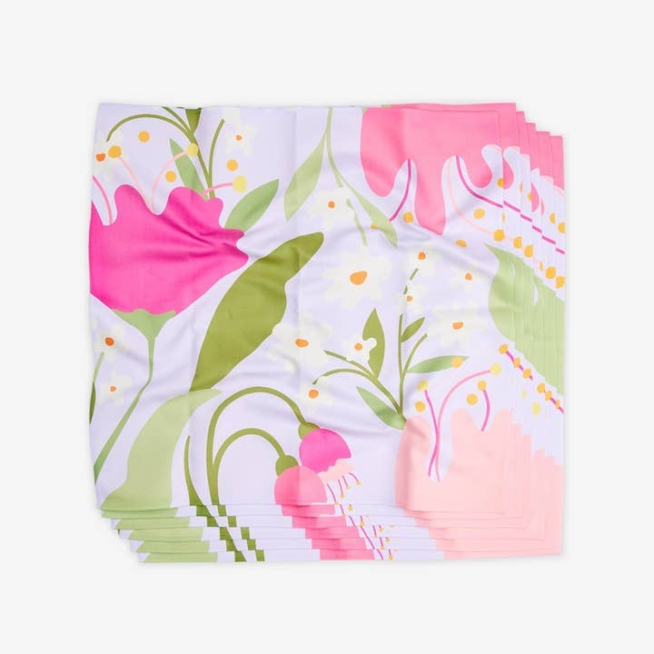 Set of six square geosuede dinner napkins with a single-sided geometric print pattern.