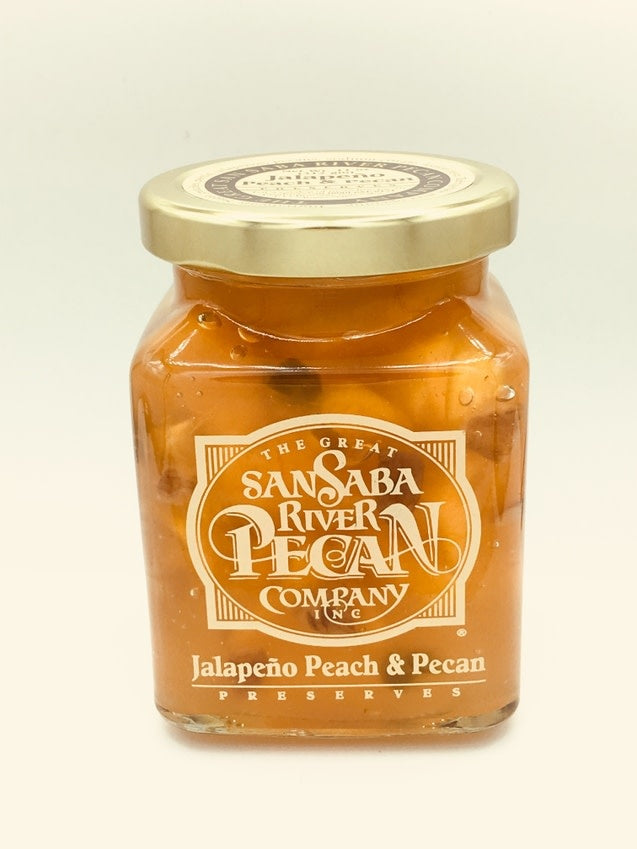 8 oz glass jar containing Texas cranberry peach pecan preserves with visible fruit chunks and a fired logo.