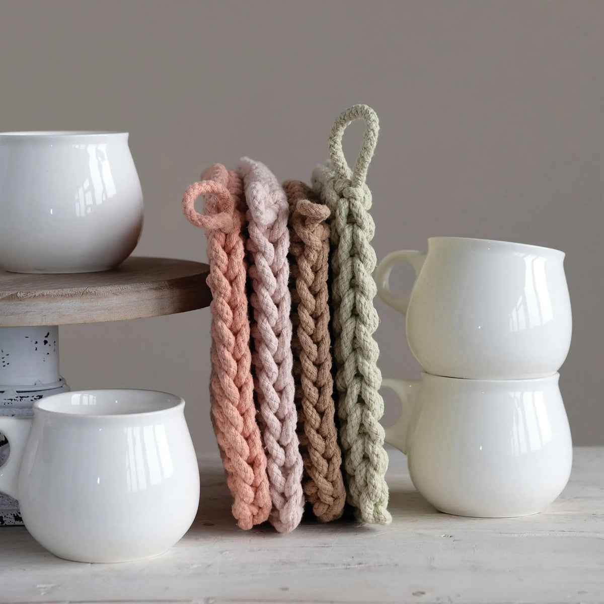8-inch square cotton crocheted potholder with a textured openwork pattern in natural off-white.