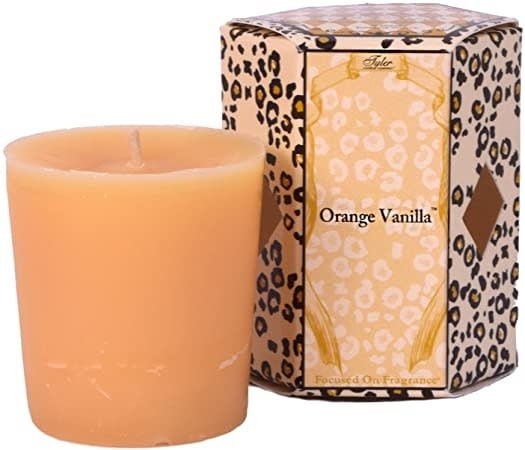 Single white votive candle in a clear glass holder.