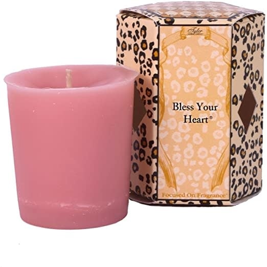 Single white votive candle in a clear glass holder with an exposed wick.