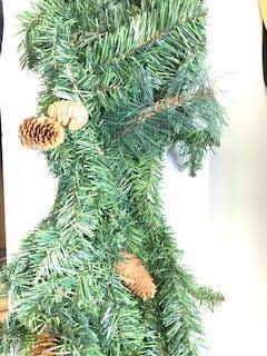 A nine-foot artificial pine garland with green foliage arranged in a natural swag silhouette.