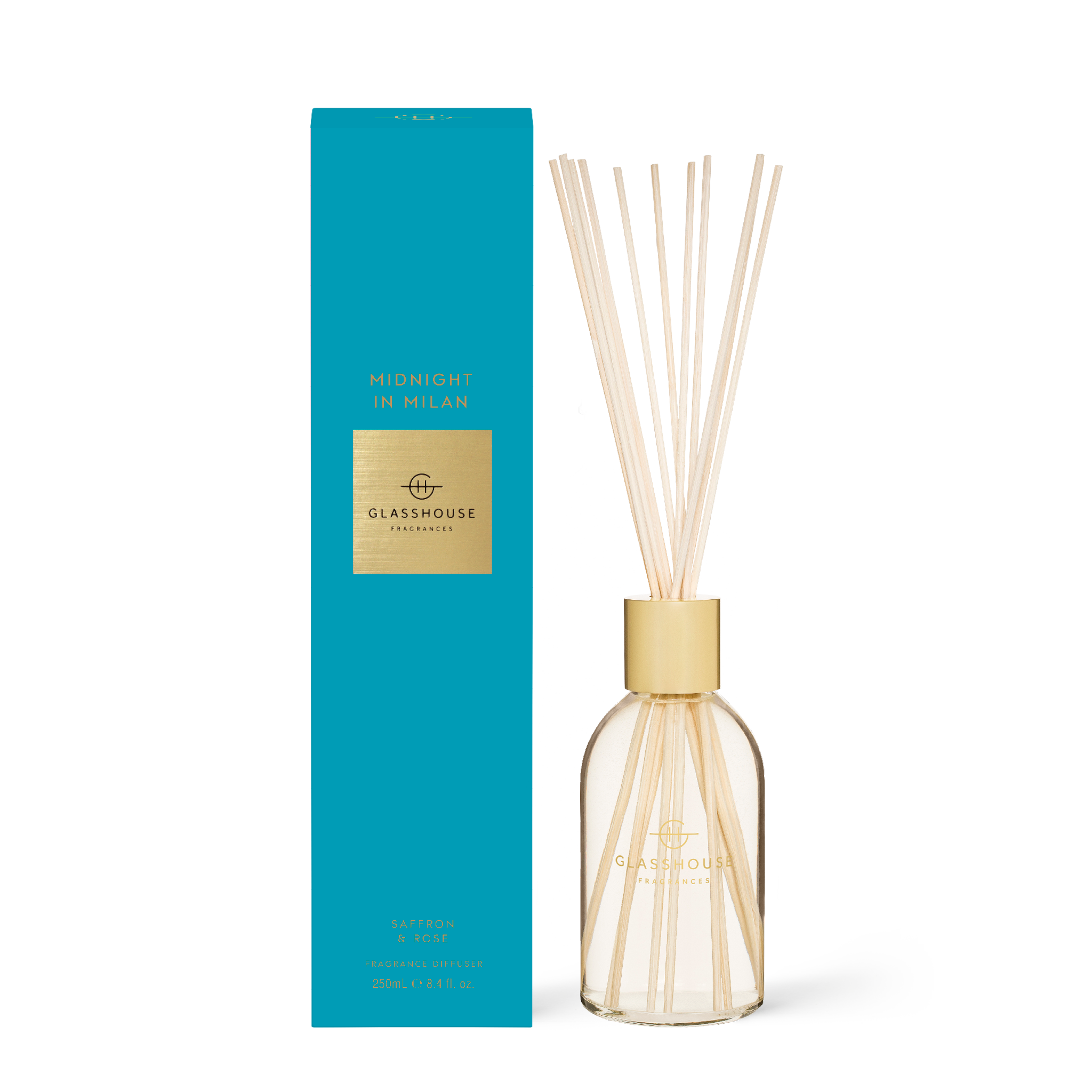 Midnight in Milan diffuser bottle with dark glass, rose-colored liquid, and wooden reeds.