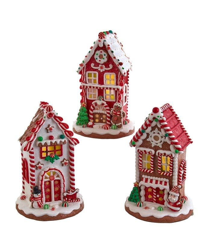 8.5-inch battery-operated gingerbread house with red and white icing trim, glittered base, candy decorations, and glowing LED light.