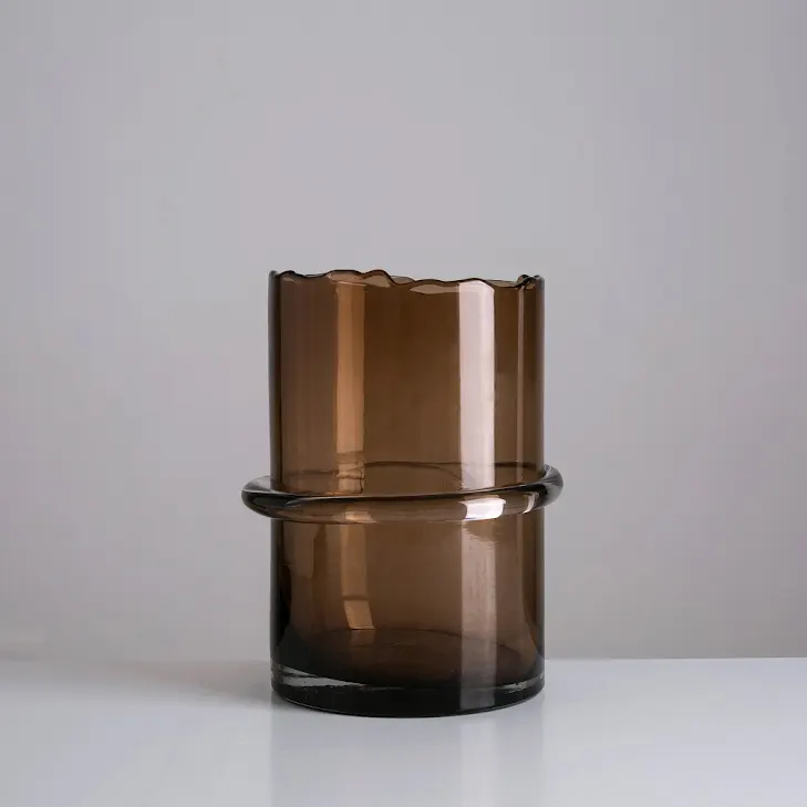 Clear glass vase with a diamond star cutout pattern on the side.