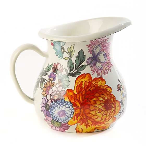 White ceramic creamer with hand-applied botanical floral transfers on a heavy-gauge steel base.