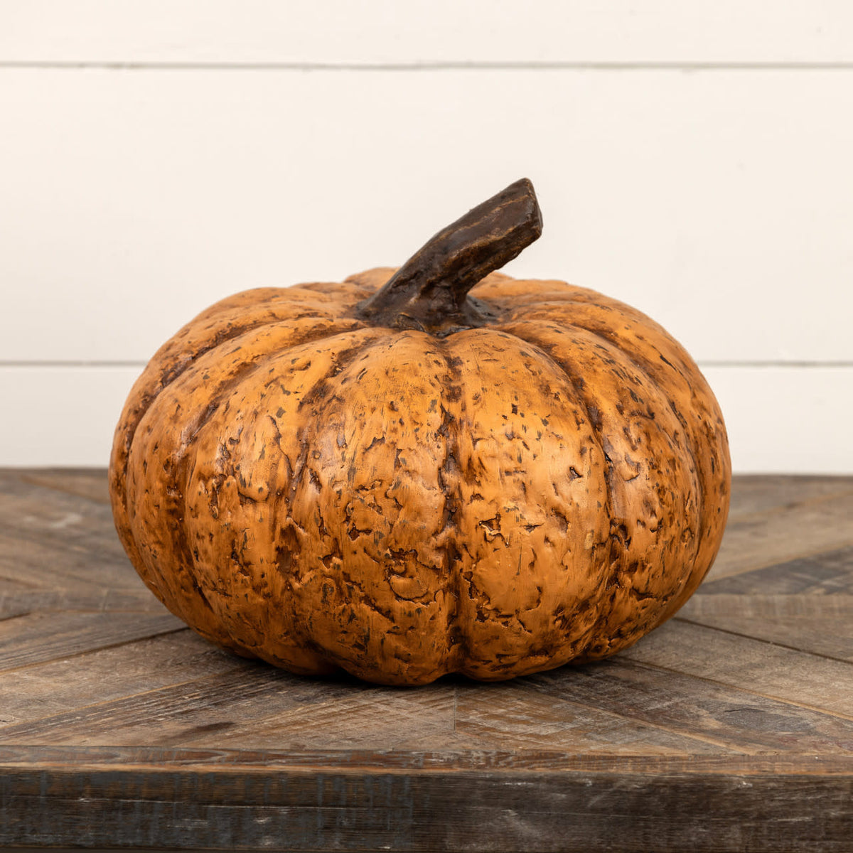 Terracotta short pumpkin with a rounded silhouette measuring approximately nine inches tall.