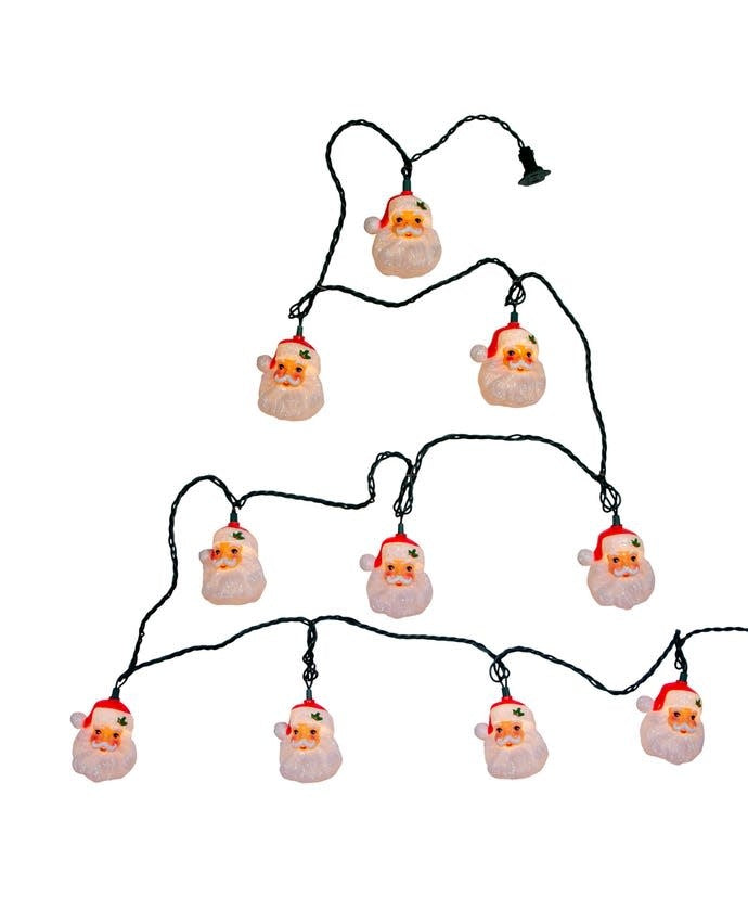 Multicolor incandescent lights shaped like a Santa head on green wire.