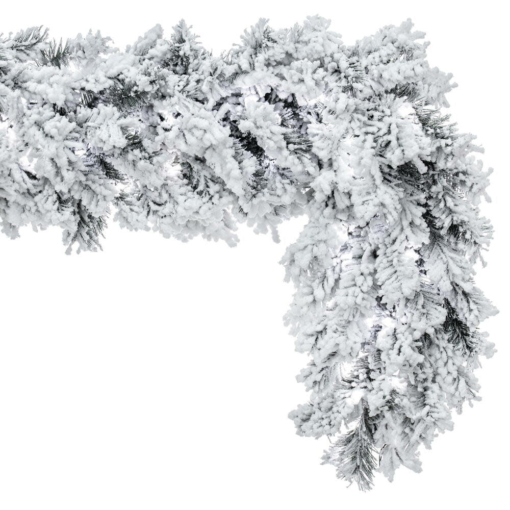 Pre-lit flocked Alaskan garland with warm white LED mini lights on a wire spine.