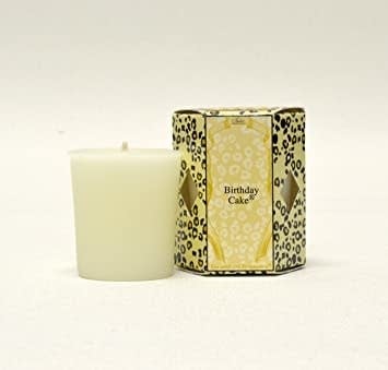 Single white votive candle in a clear glass holder with an exposed wick.