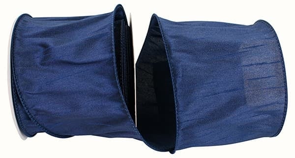 A roll of 4-inch wide navy blue Dupioni wired edge ribbon made of 100% polyester.