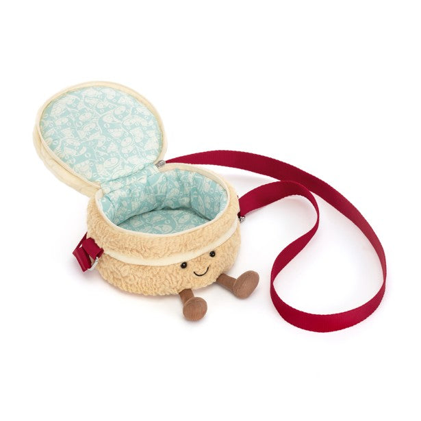Open Amuseables Birthday Cake Bag with a plush beige exterior, smiling face, and red strap.