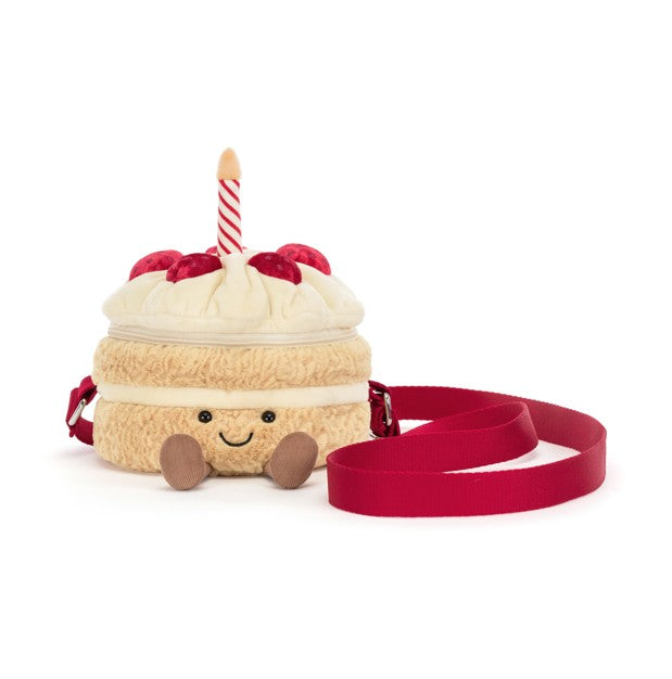 Plush birthday cake bag with a smiling face, red berries, a striped candle, and a red strap.