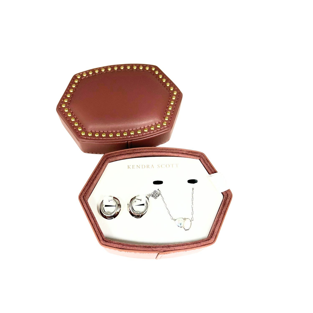 Kendra Scott Tatum necklace and Mikki huggie earrings in a brown studded hexagonal jewelry box.
