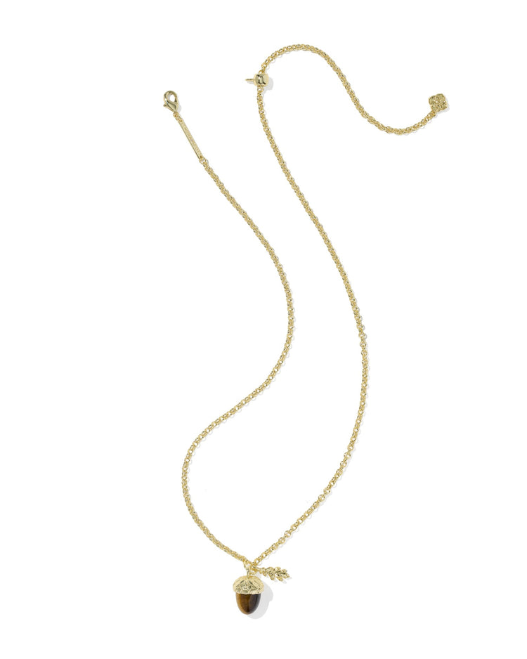 Gold chain necklace with a tiger's eye acorn pendant and a small gold leaf charm.