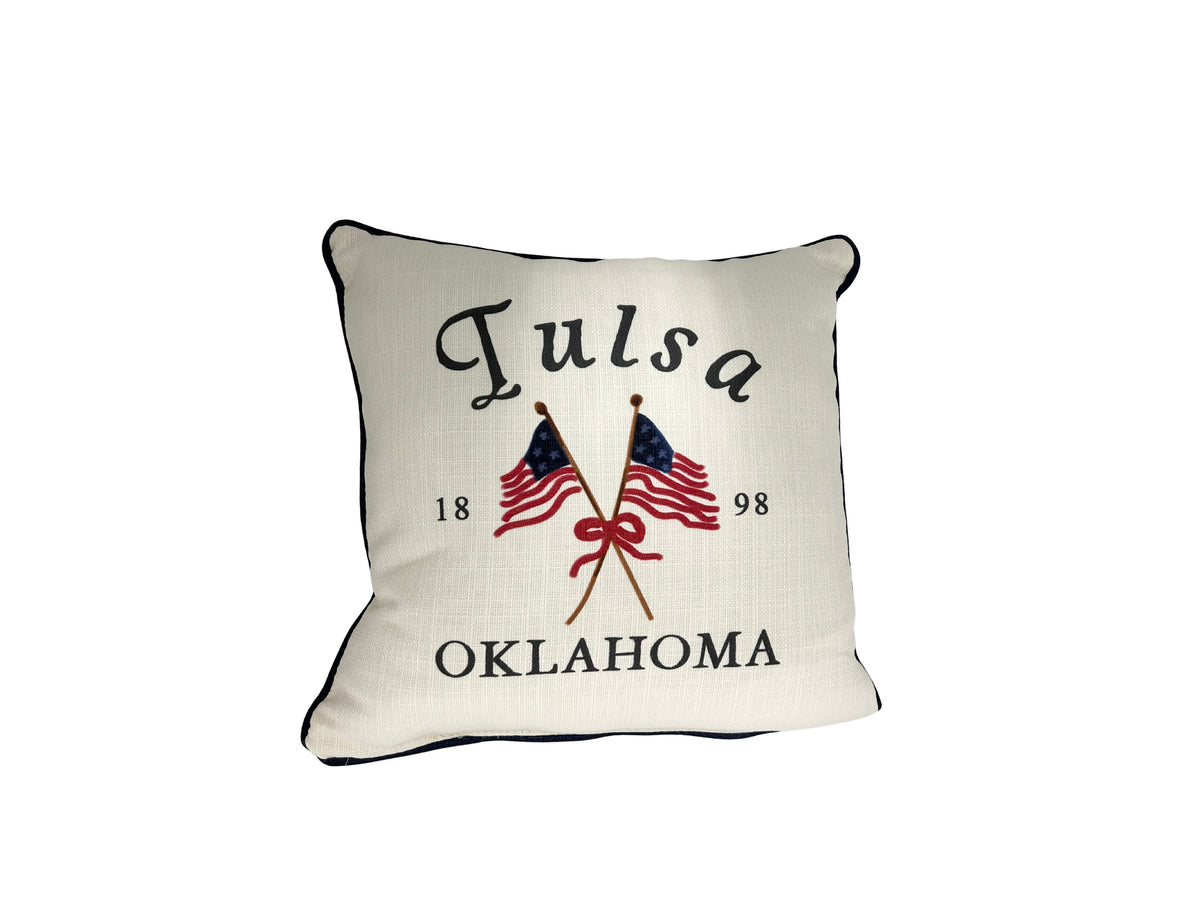 Square cream pillow with 'Tulsa Oklahoma' text, crossed American flags, and '1898' in black ink.