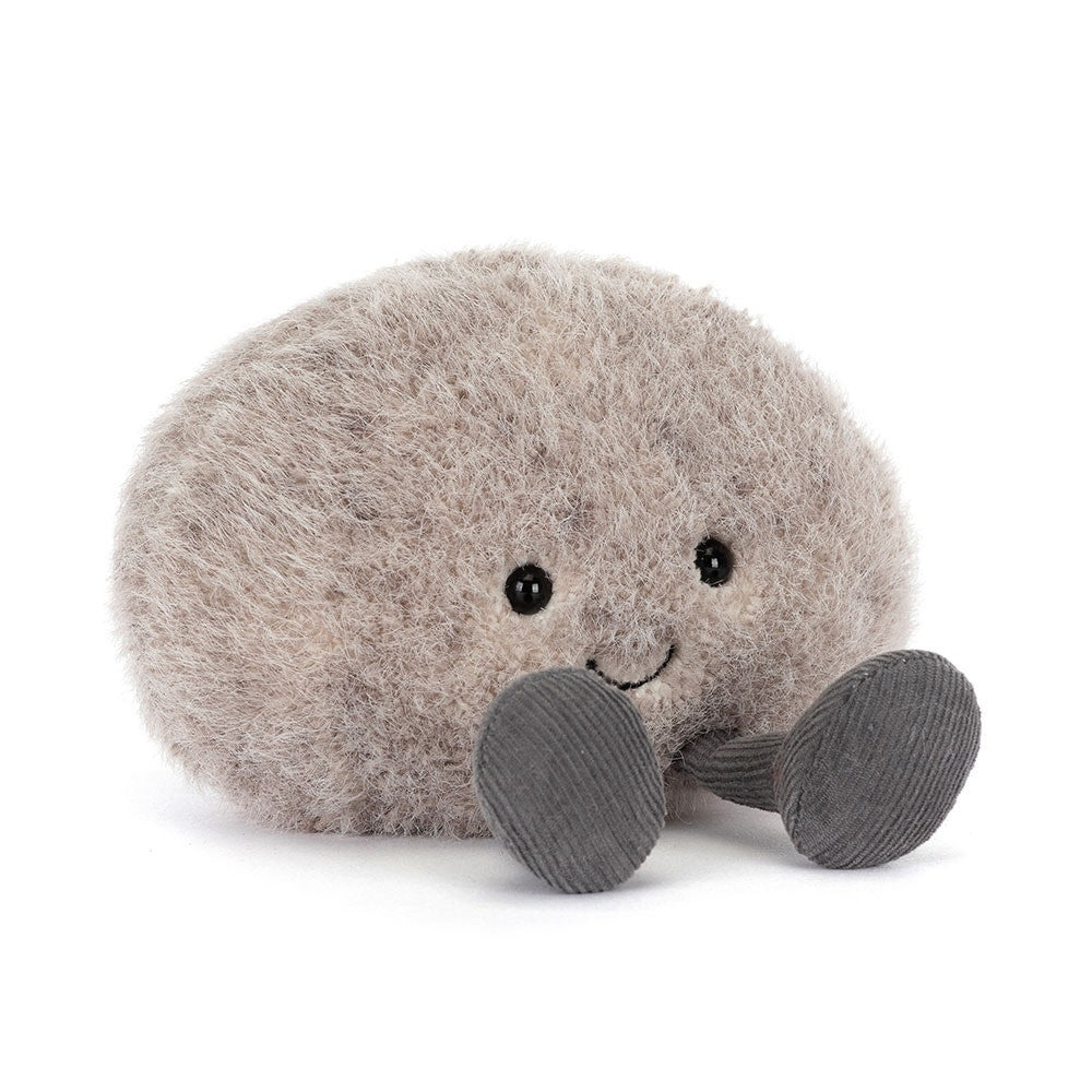 Jellycat Amuseables Pebble plush toy with fuzzy grey fur, a smiling face, and corduroy legs.