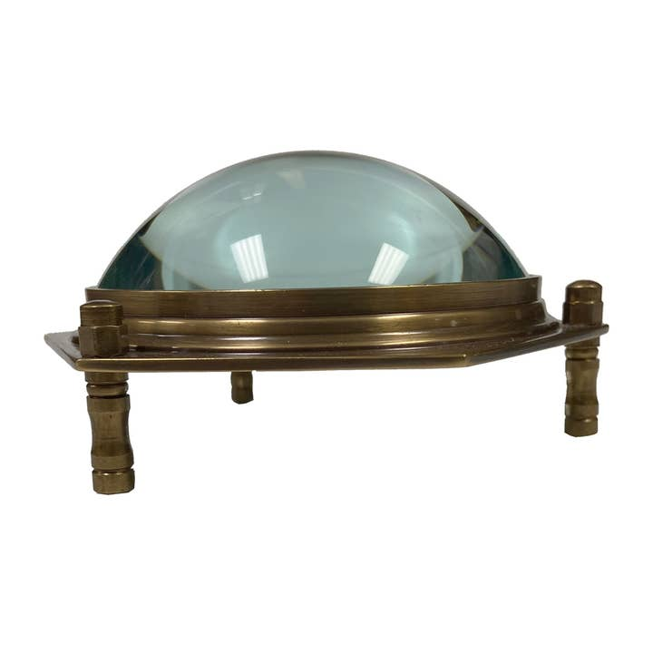 Antiqued brass hexagonal dome desk magnifier with 3x glass lens on three raised legs.