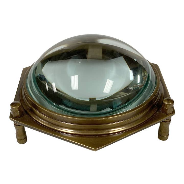 Antiqued brass hexagonal dome desk magnifier with 3x glass lens and three raised legs.