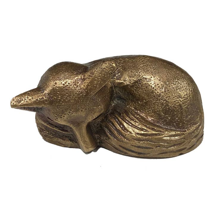 Antiqued brass sleeping fox figurine with detailed etched fur texture on a white background.