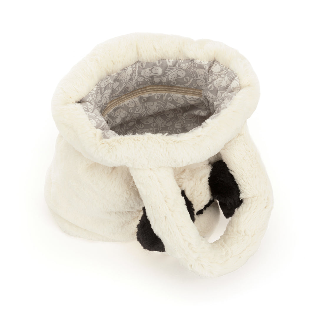 Interior view of the white faux fur Rufferty Puppy Handbag with a patterned lining and zipper pocket.