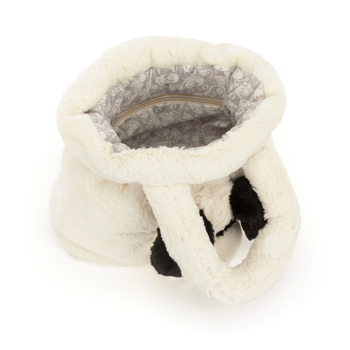 Interior view of the white faux fur Rufferty Puppy Handbag with a patterned lining and zipper pocket.