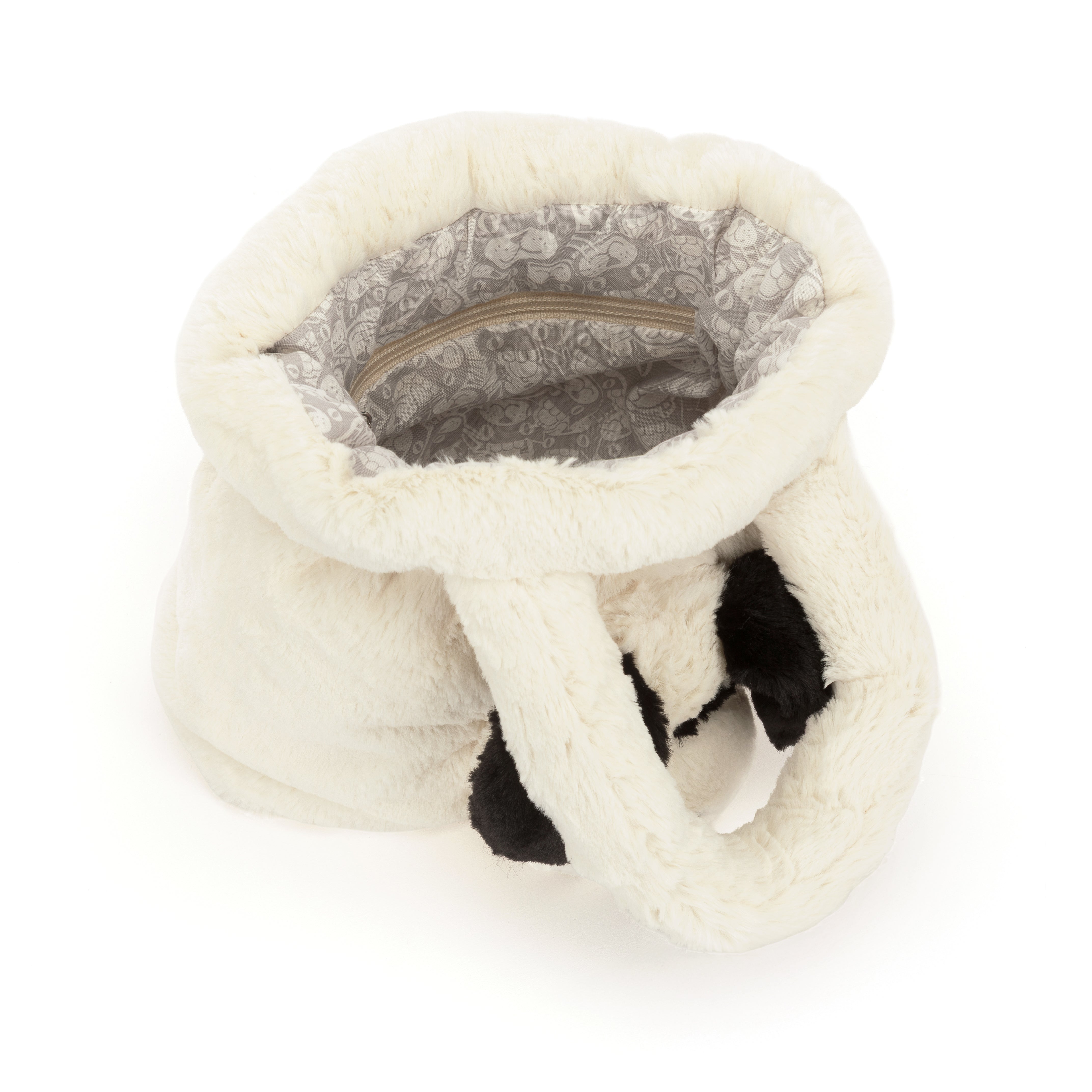 Interior view of the white faux fur Rufferty Puppy Handbag with a patterned lining and zipper pocket.