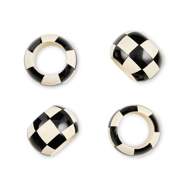 Set of four black and white checkered wood napkin rings with a square silhouette.