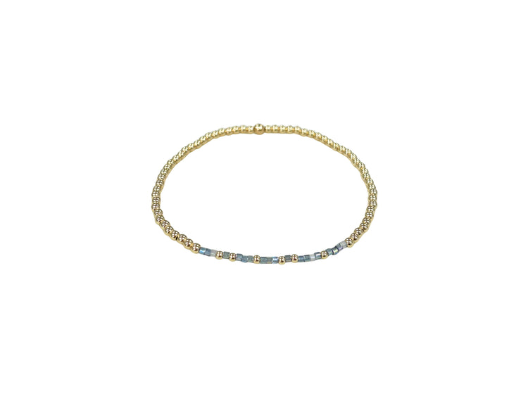 Gold-filled elastic bracelet featuring Morse code beads spelling 'Blessed' with a waterproof finish.