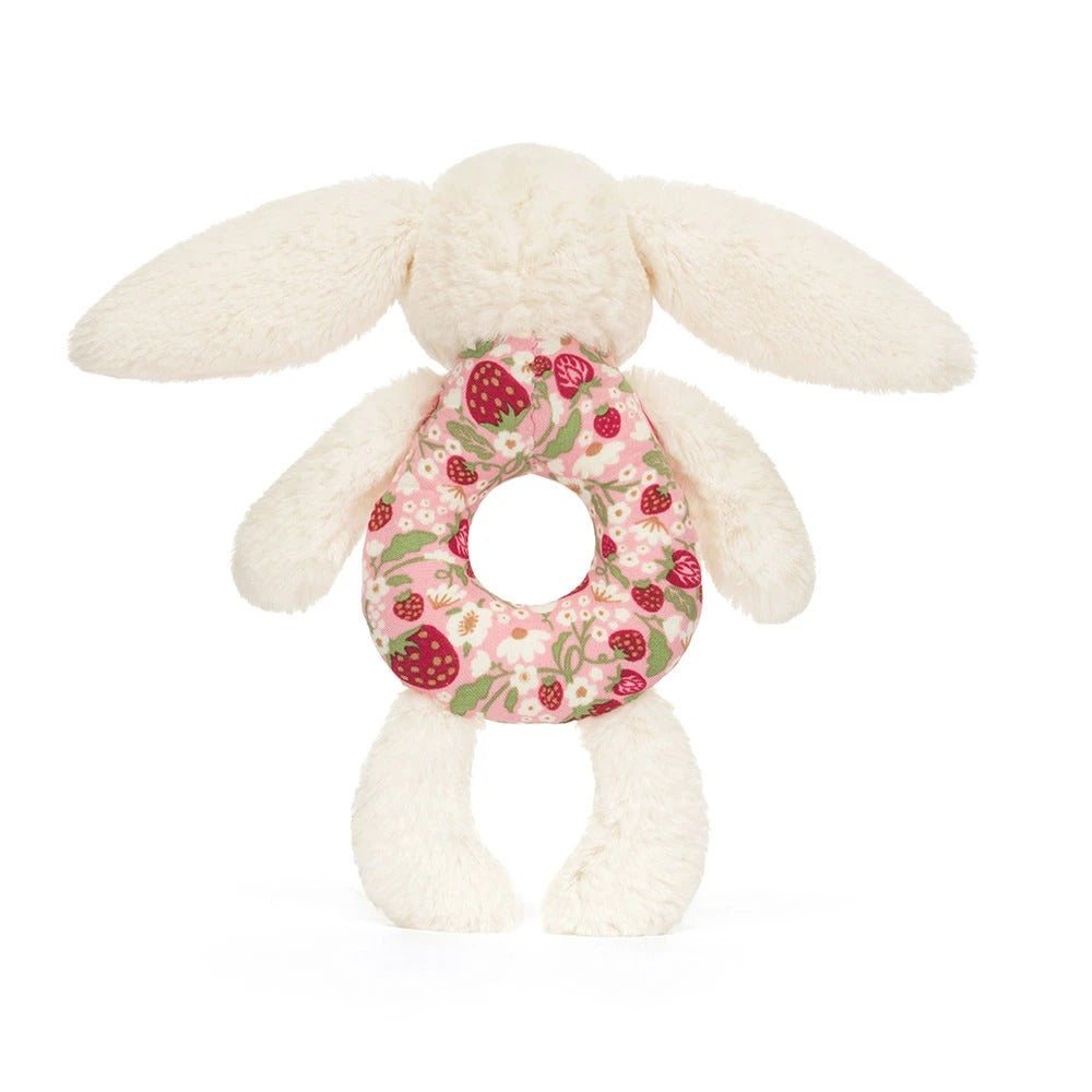 Cream bunny ring rattle with a pink floral and strawberry pattern fabric ring.