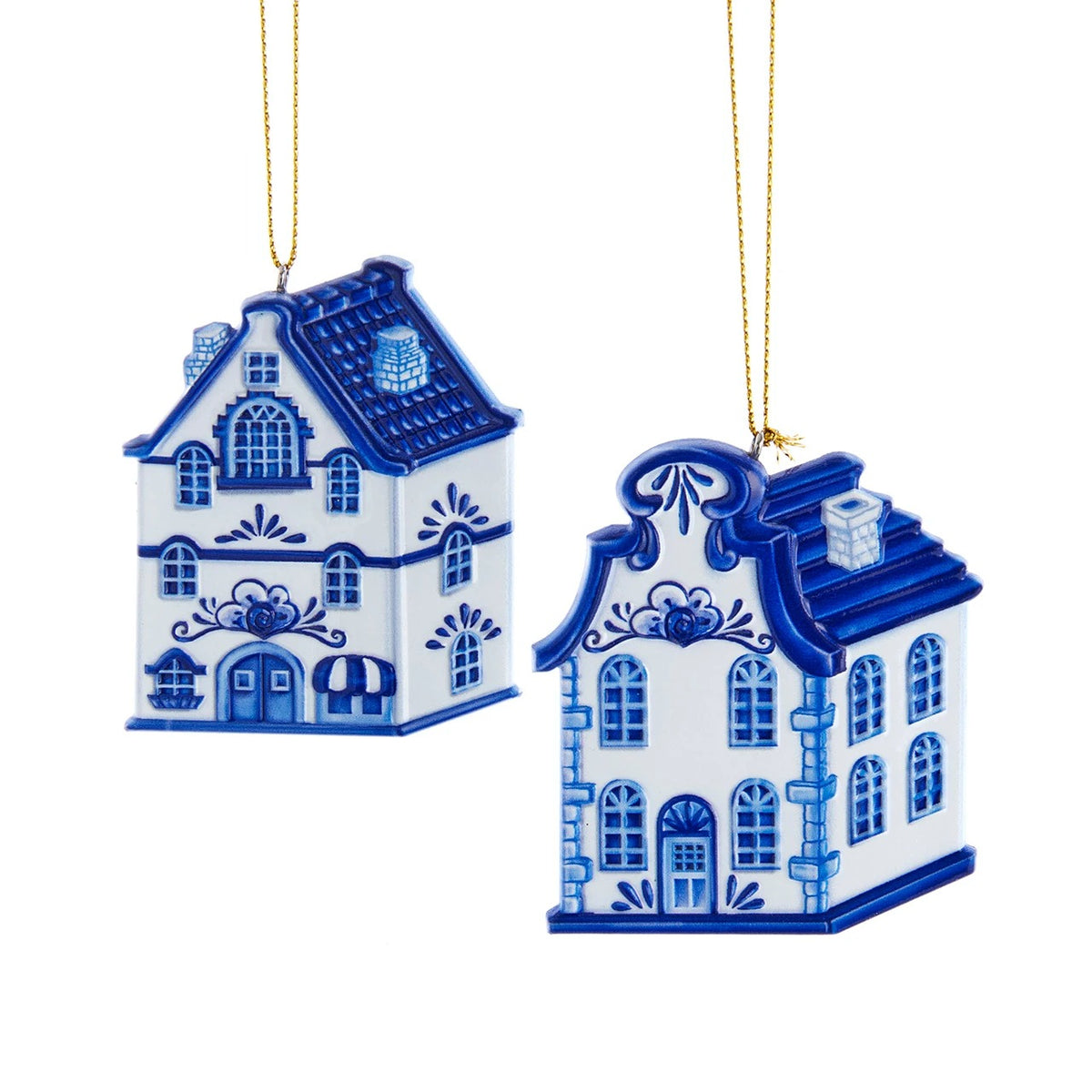 Two blue and white resin house ornaments with intricate patterns and gold hanging strings.