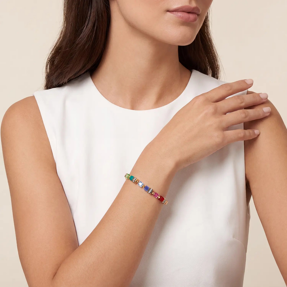 Woman wearing a Bracelet Mini Cubes Multicolor Rainbow Gold with vibrant Swarovski crystals.