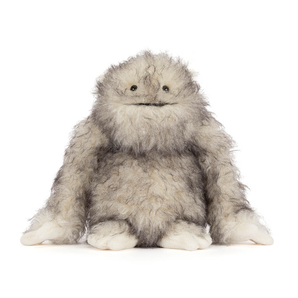 Bretti Yeti plush toy with fluffy grey and white fur, small black eyes, and a stitched smile.