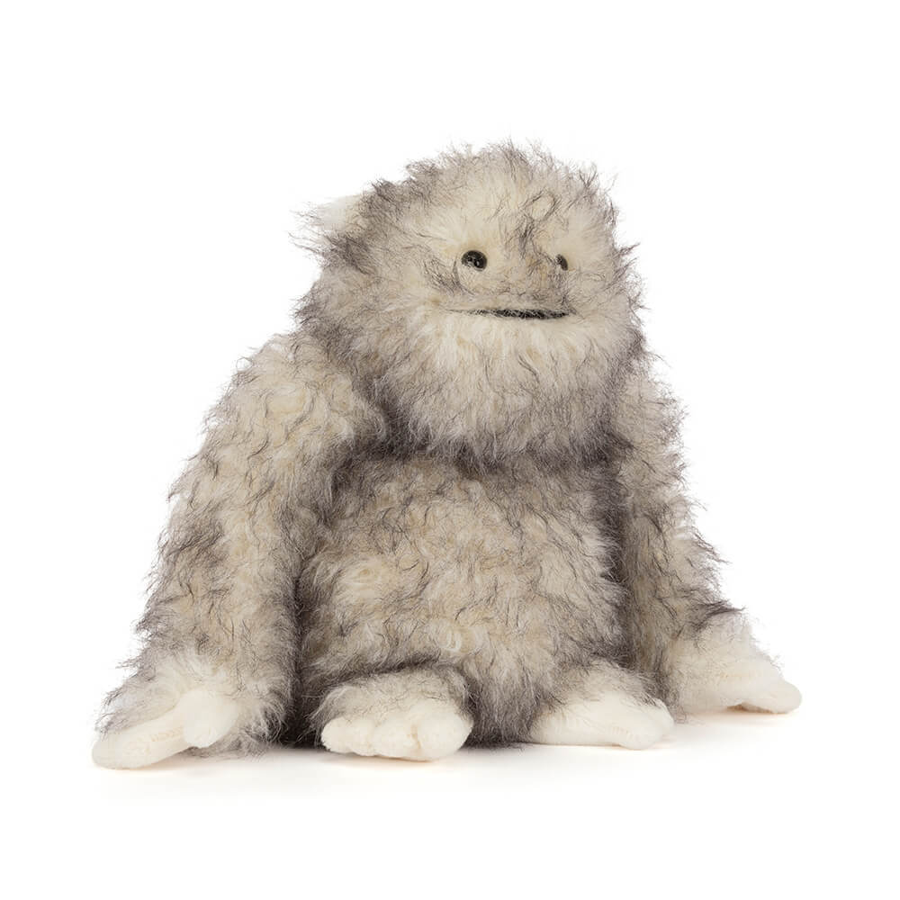 Bretti Yeti plush toy with fluffy grey and white fur, black eyes, and a small smile.