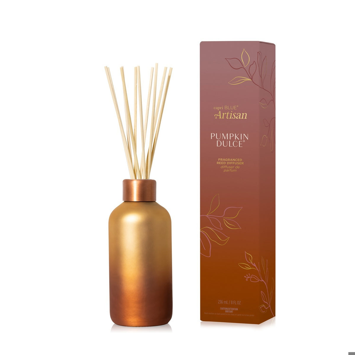 Capri Blue Pumpkin Dulce reed diffuser in a copper gradient glass bottle next to its matching box.