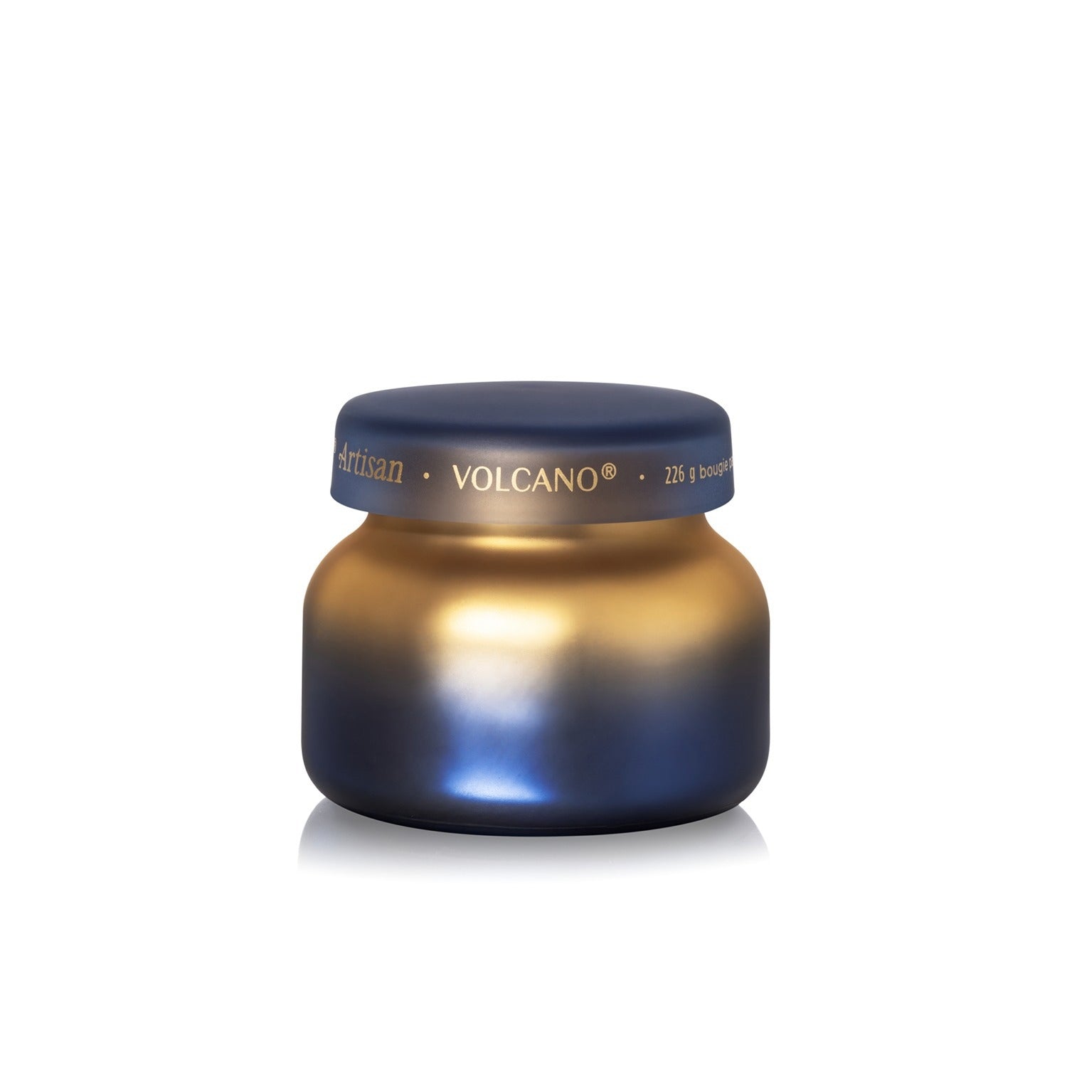 Capri Blue Volcano Artisan Tuscan Radiance Petite Candle in a blue and gold ombre glass jar.