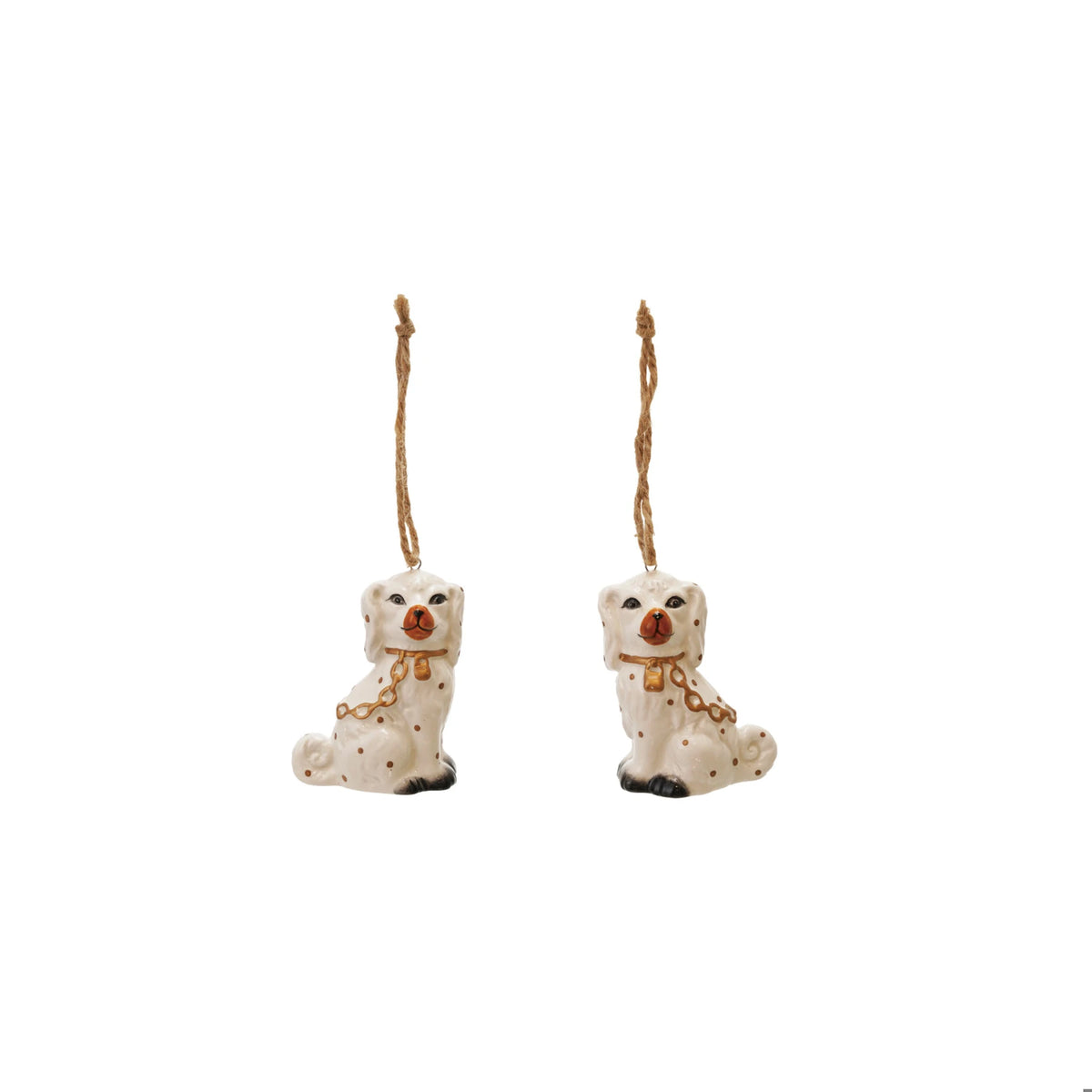 Two white ceramic Staffordshire dog ornaments with gold chain collars and jute hanging strings.