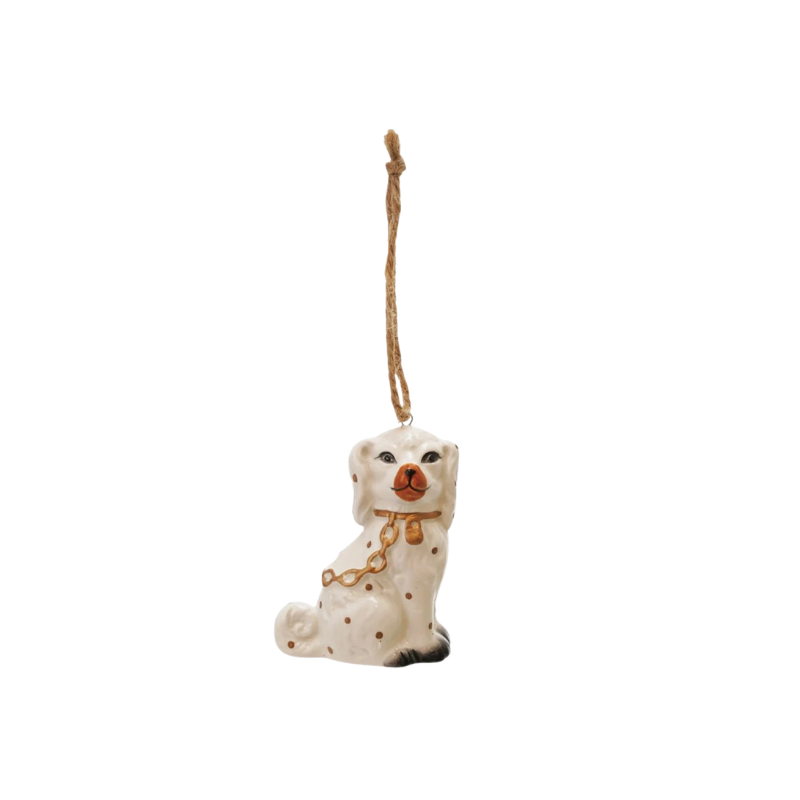 Ceramic Staffordshire dog ornament with white glaze, gold chain detail, and twine hanging loop.