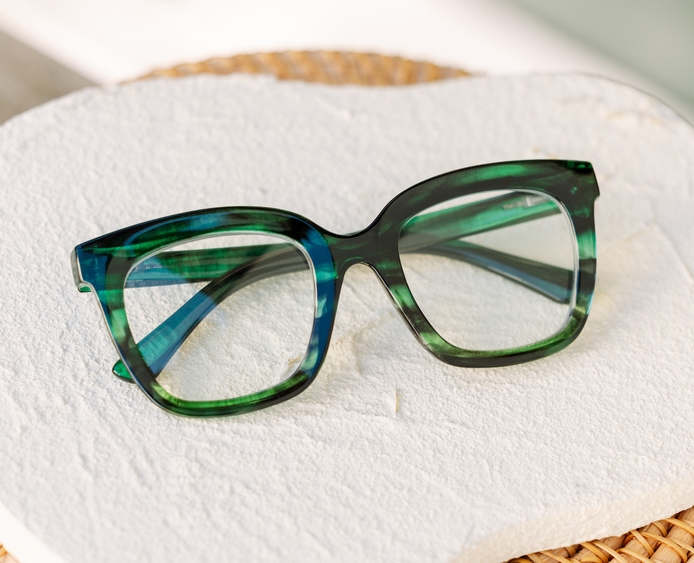 Cleo oversized square blue light glasses in emerald ombre horn green streaked acetate.