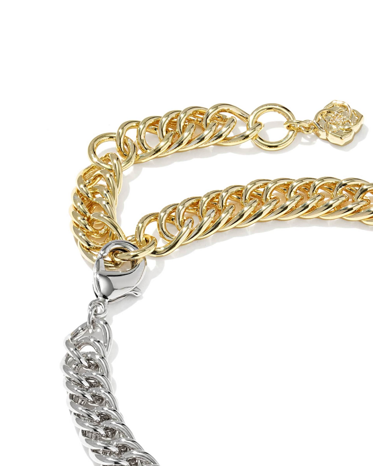 Close-up of a mixed metal Colette chain bracelet featuring gold and silver curb links and a clasp.