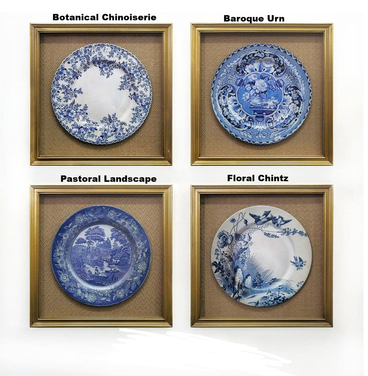 Four framed blue and white decorative plate prints in gold frames with burlap mats.