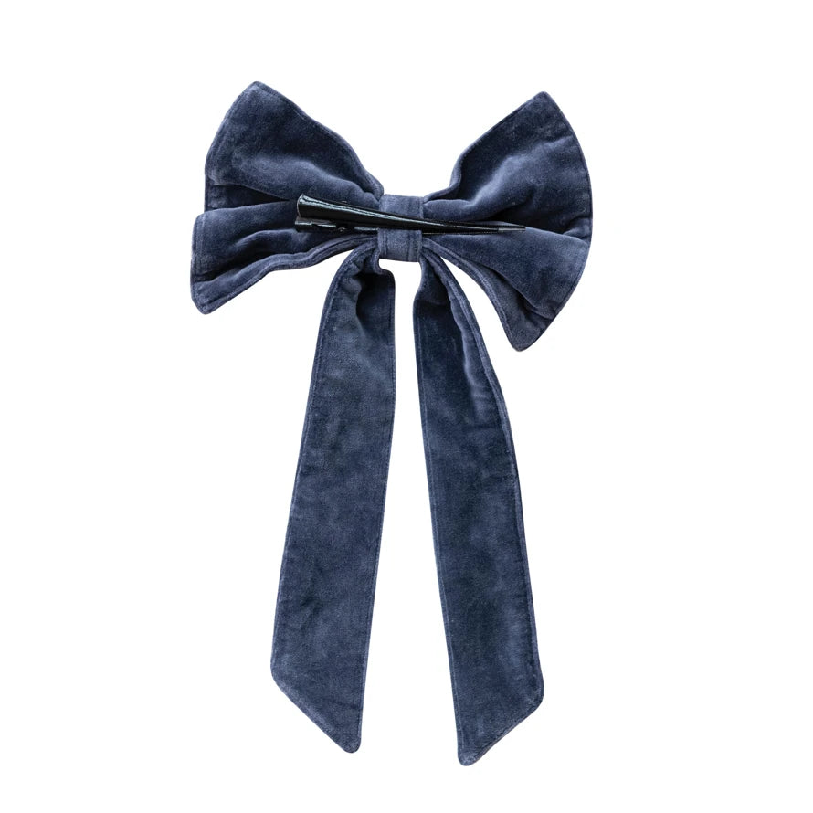 Navy cotton velvet clip-on bow with long ribbon tails and a black iron clip on the back.