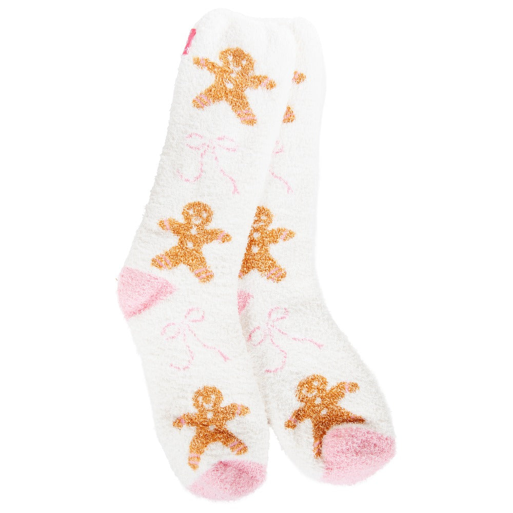 White fuzzy crew socks with gingerbread man and pink bow patterns, featuring pink heels and toes.