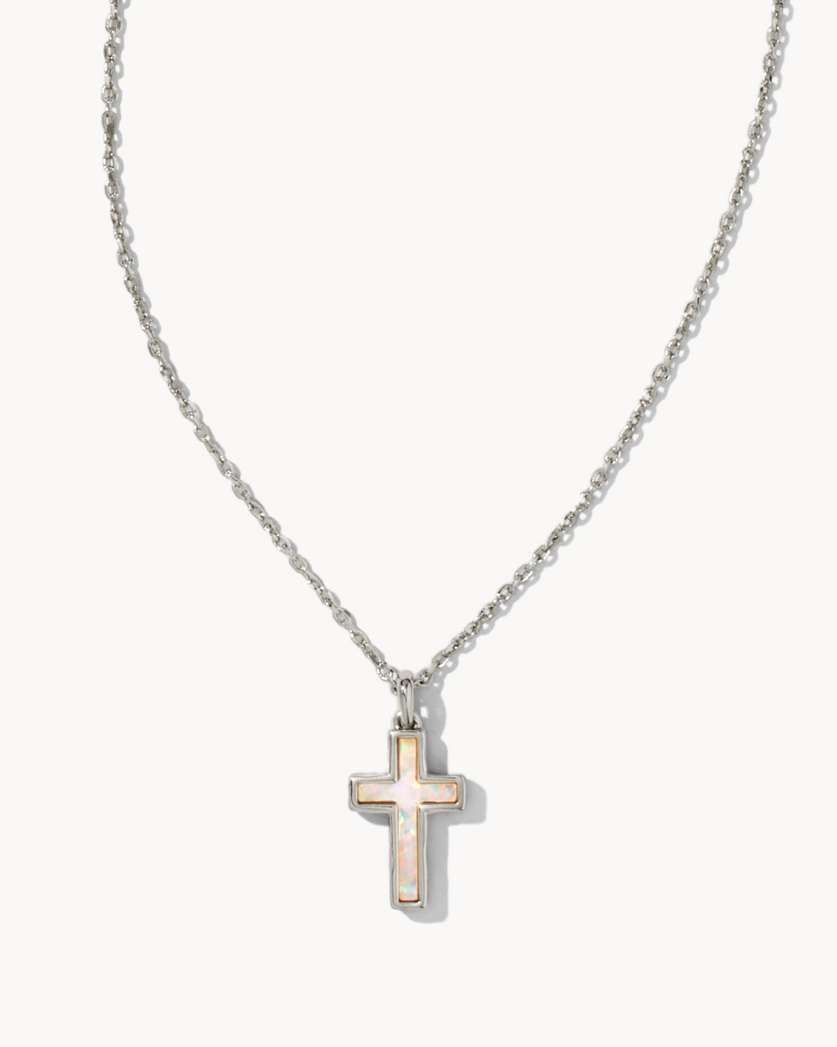 Cross pendant necklace in rhodium over brass with a white lab-grown opal inlay on a silver chain.